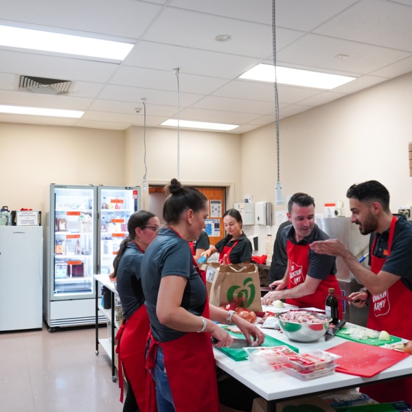 A group of volunteers preparing lunch in a kitchen.