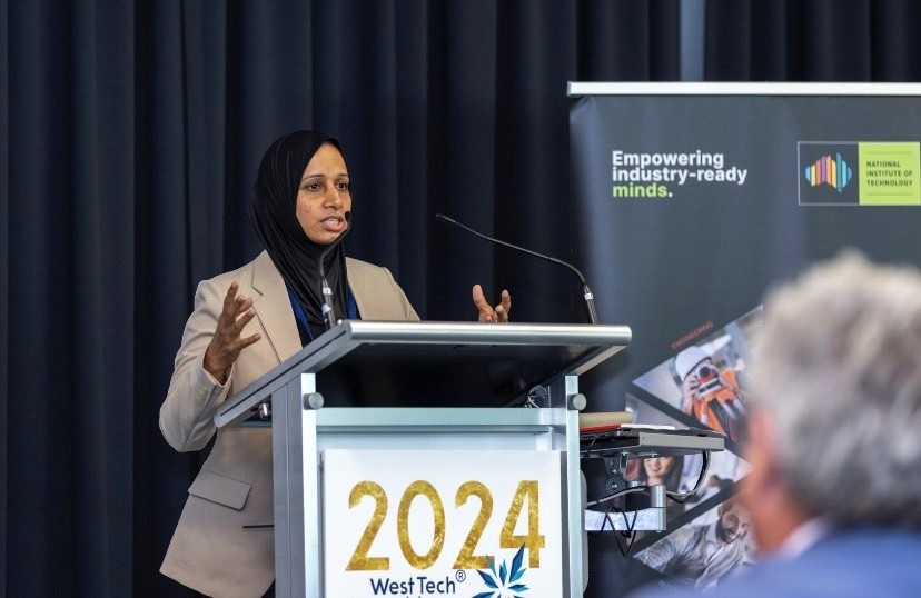Woman in a headdress giving a speech at a podium