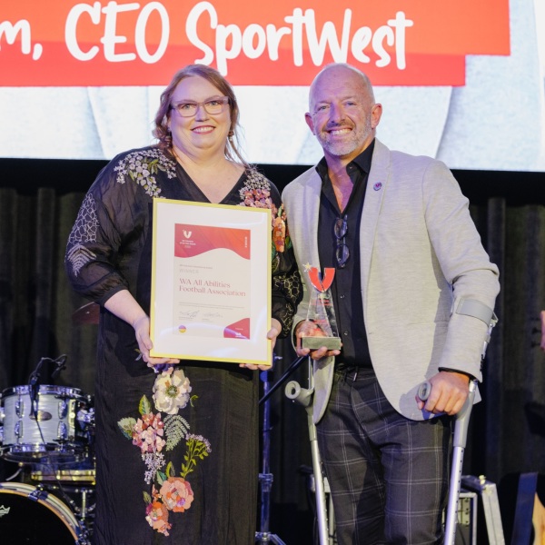 2025 Inclusive Volunteering Award recipient, WA All Abilities Football, receiving their award onstage