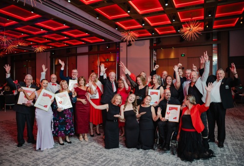 2025 WA Volunteer of the Year Award recipients and finalists taking a group photo with their hands in the air