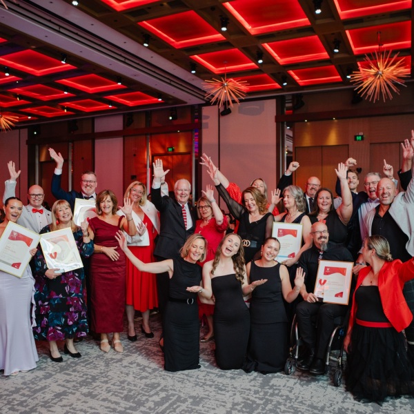 2025 WA Volunteer of the Year Award recipients and finalists taking a group photo with their hands in the air