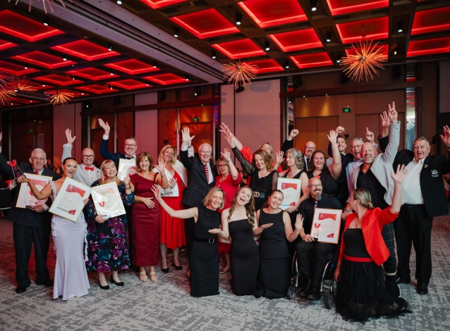 2025 WA Volunteer of the Year Award recipients and finalists taking a group photo with their hands in the air