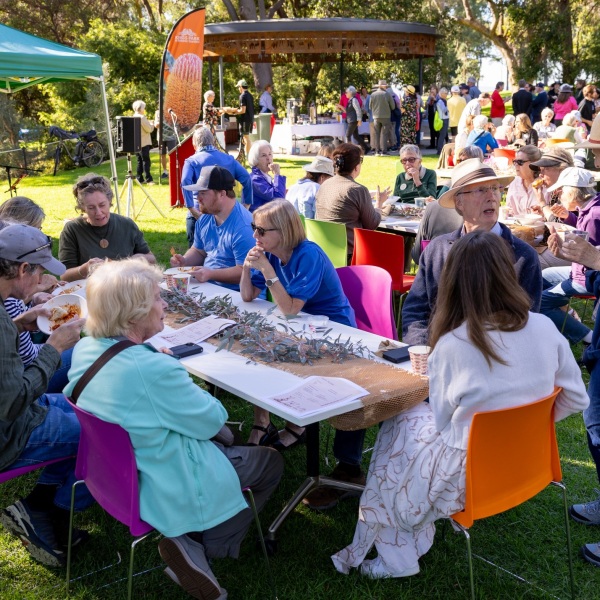 A group of volunteers having morning tea in a garden