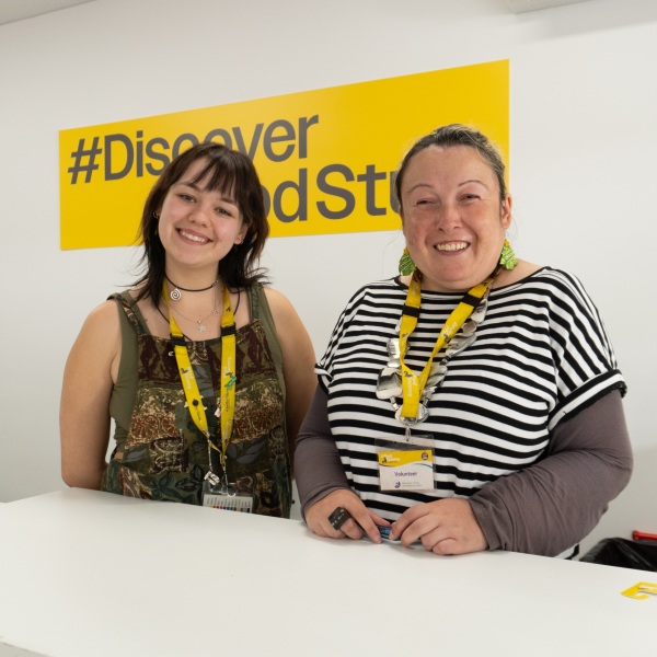 Two op shop volunteers behind the counter