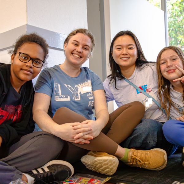 Four young people posing for a photo together