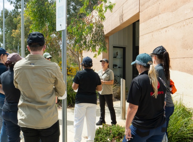 A woman addressing a group of people